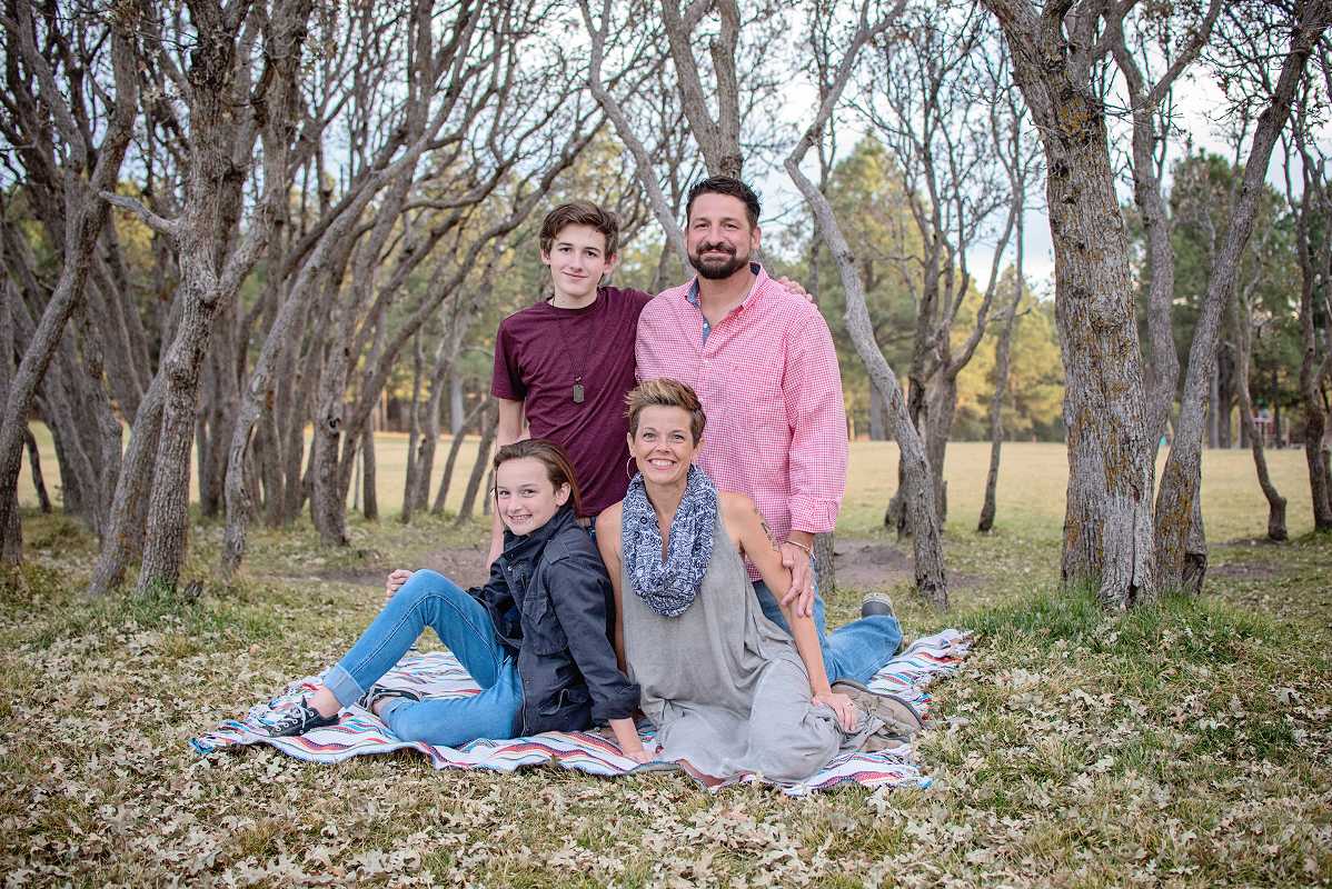 Forman family poses for group photo in a forrest